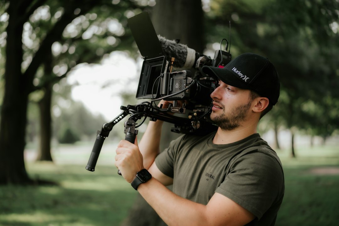 Camera operator filming with a broadcast camera on a studio set